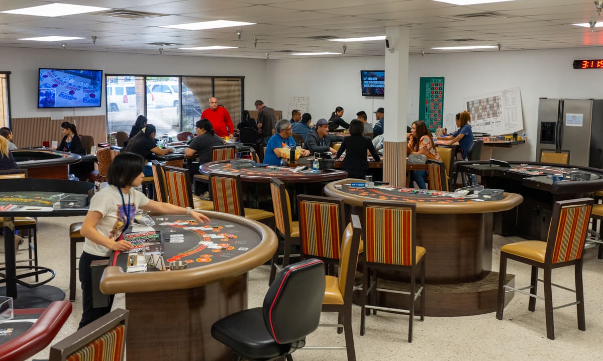 Clean overview of the Las Vegas casino training facility with multiple full-size tables